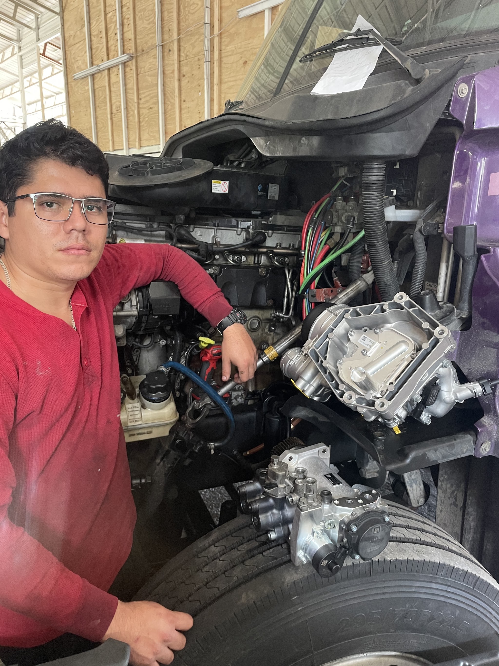 Under the hood of a heavy truck, working on the engine