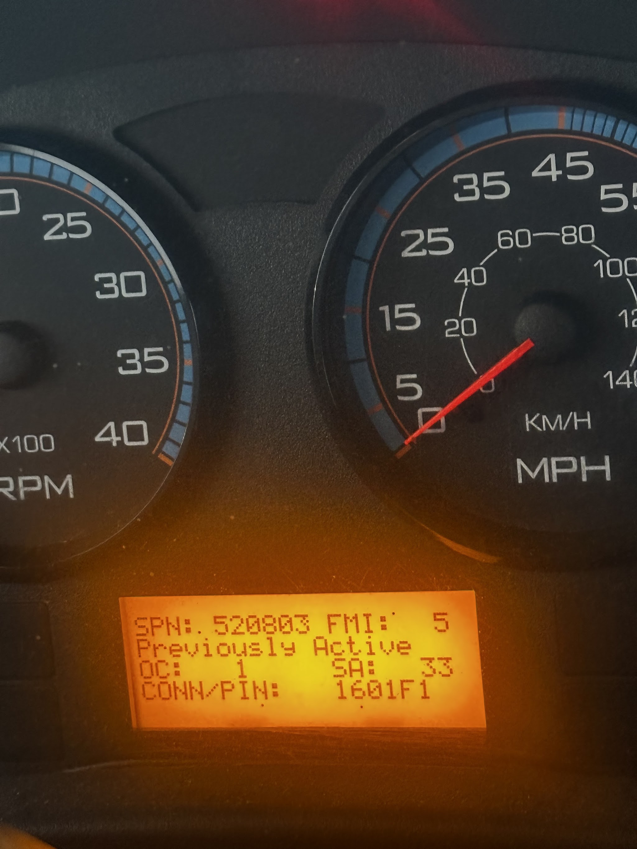 A truck dash showing an active fault code